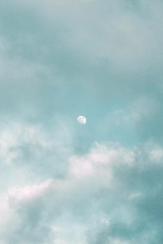 a plane flying through a cloudy blue sky, by James Morris, trending on unsplash, minimalism, large glowing moon, in pastel shades, 15081959 21121991 01012000 4k, rinko kawauchi