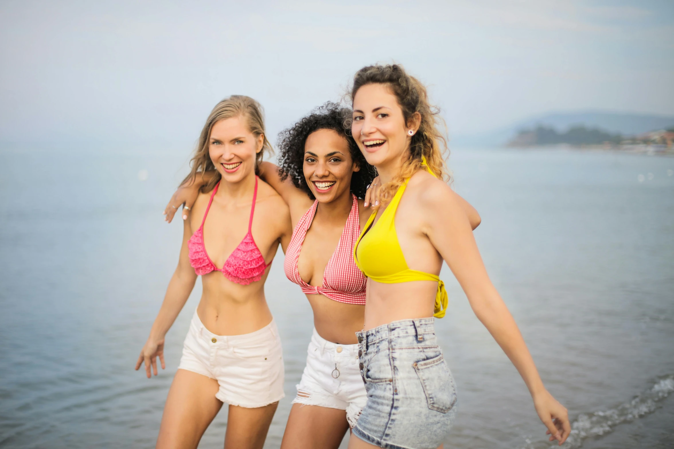 a group of women standing next to each other on a beach, bralette, playful smile, avatar image, naturecore