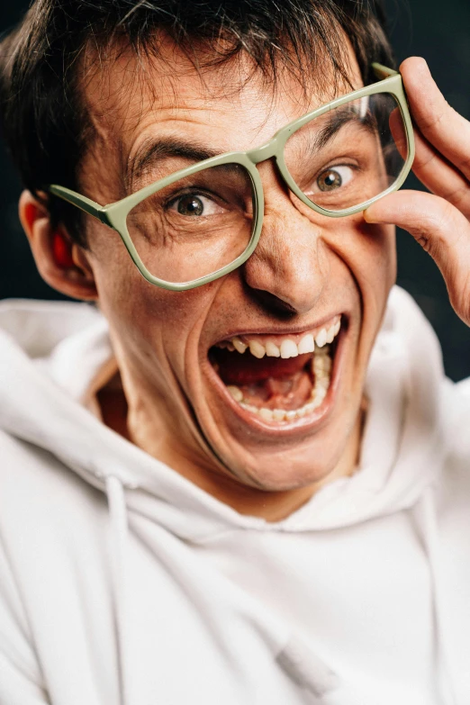 a close up of a person wearing glasses, inspired by Leo Leuppi, antipodeans, screaming at the camera, laughingstock, max hay, comedian is funny