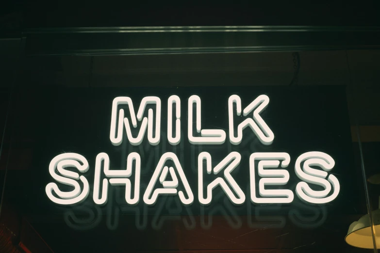 a neon sign that says milk shakes, inspired by Elsa Bleda, trending on unsplash, broken shackles, high quality photo, alessio albi, 1970s photo