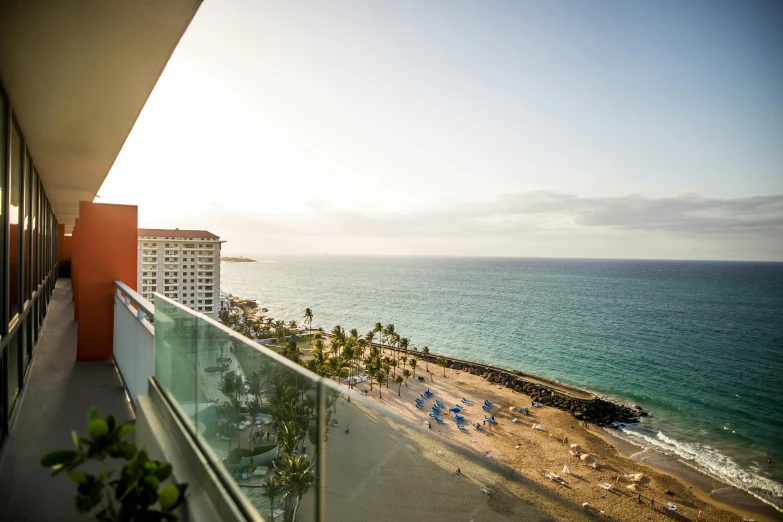 a balcony with a view of the ocean, by Daniel Lieske, pexels contest winner, happening, barcelo tomas, turquoise and orange, exterior shot, overlooking the beach