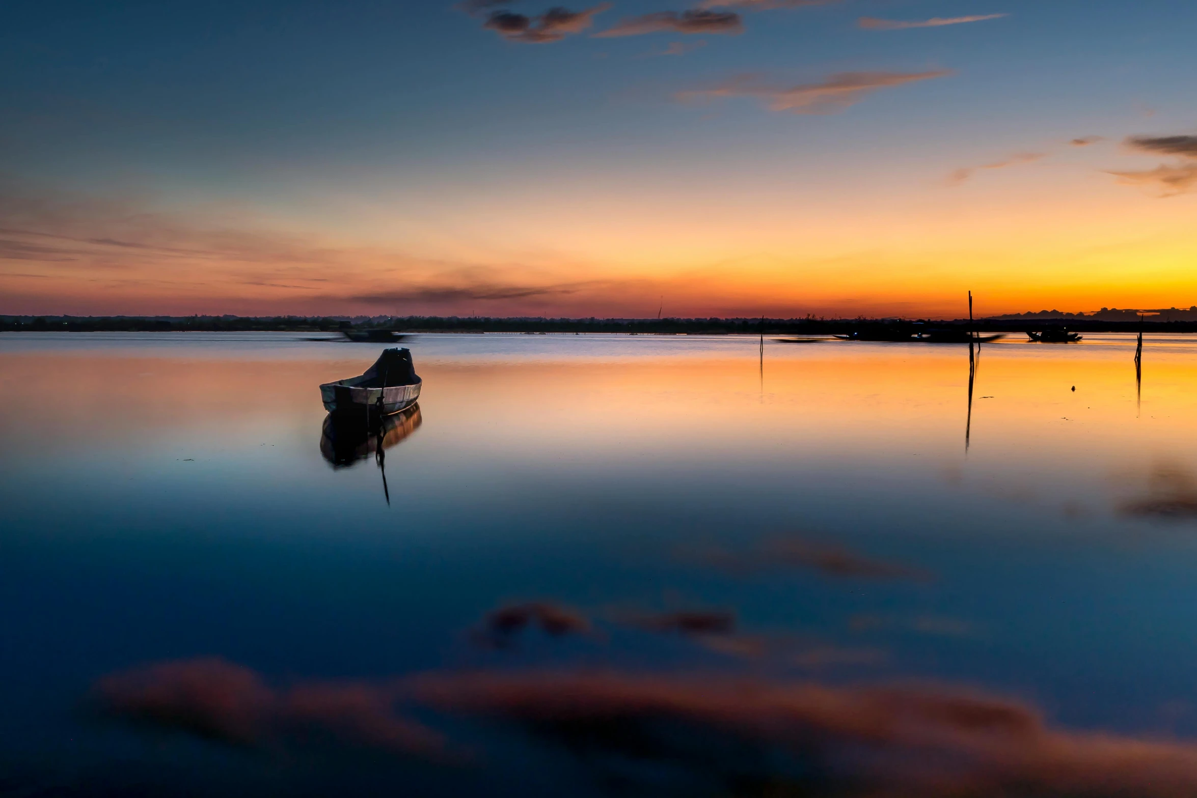 a boat sitting on top of a body of water, by Eglon van der Neer, unsplash contest winner, magic hour photography, calm vivid colors, reflect, horizon