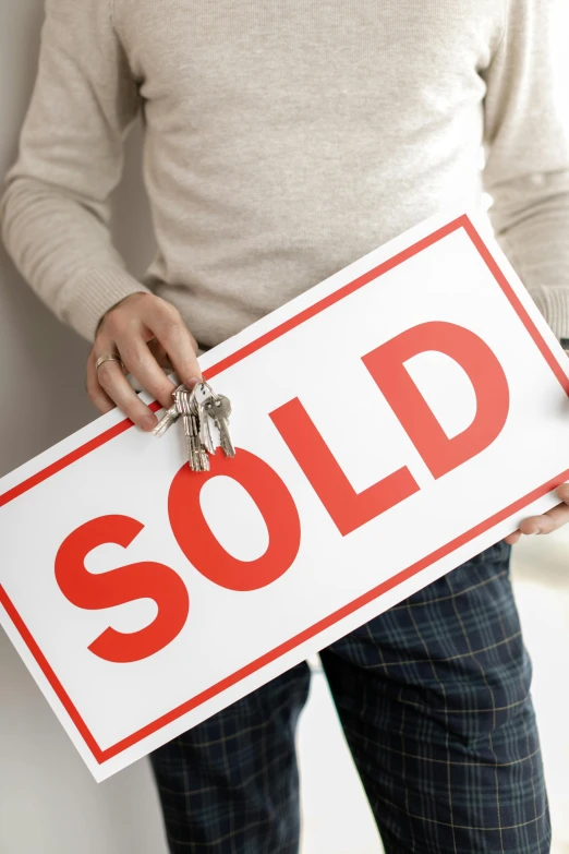 a man holding a sold sign in his hands, pexels contest winner, thumbnail, home, getty images, large format