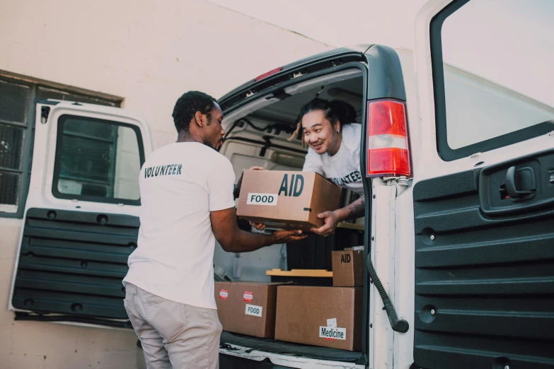 two men loading boxes into the back of a van, pexels contest winner, hurufiyya, hunger, avatar image, healthcare, instagram picture