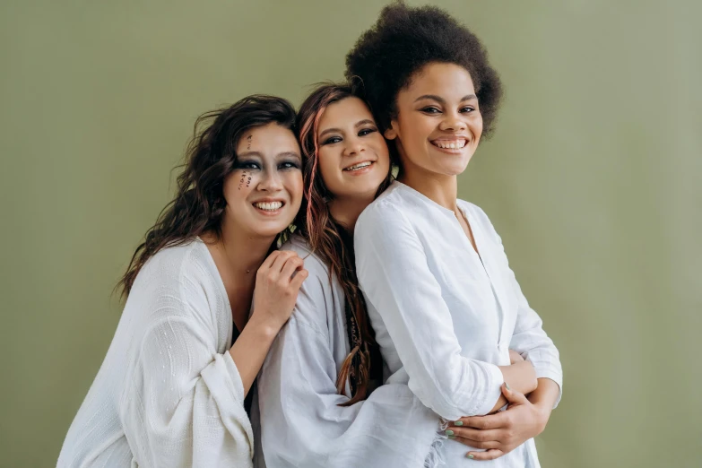 a group of three women standing next to each other, pexels contest winner, antipodeans, mixed race, wearing white pajamas, #green, brunettes