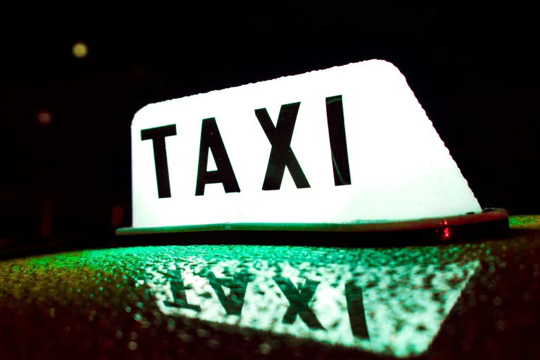 a white taxi sign sitting on top of a car, by Joe Bowler, unsplash, happening, red and green lighting, underworld, tar - like, getty images