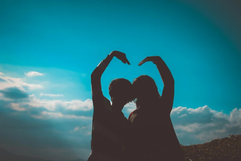 two people making a heart with their hands, pexels contest winner, clear blue skies, profile image, stylized silhouette, ad image