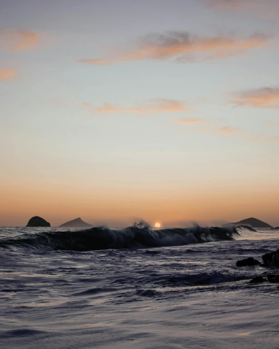 a person riding a surfboard on a wave in the ocean, it is sunset, ocean in the distance, profile image