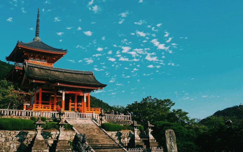 a building sitting on top of a lush green hillside, inspired by Torii Kiyomitsu, pexels contest winner, blue clear skies, guangjian, youtube thumbnail, chinese temple