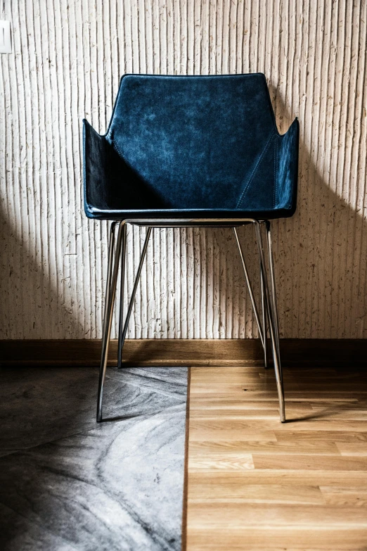 a blue chair sitting on top of a hard wood floor, by Adam Marczyński, unsplash contest winner, modernism, leather and suede, polished concrete, 15081959 21121991 01012000 4k, tall