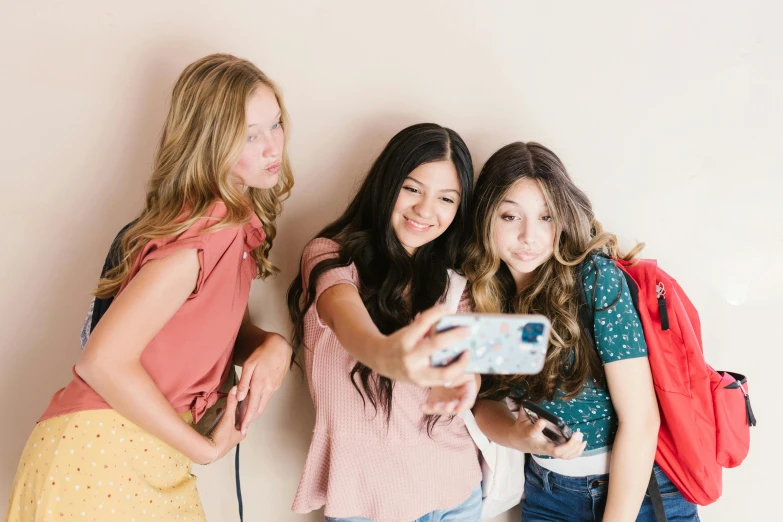 a group of young women standing next to each other, a picture, trending on pexels, happening, kids, she is holding a smartphone, sydney sweeney, avatar image