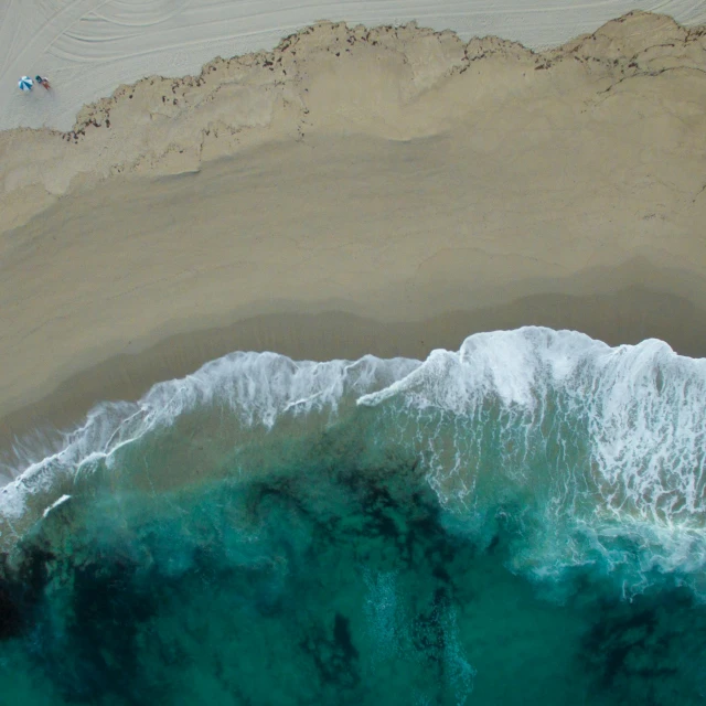 a large body of water next to a sandy beach, by Robbie Trevino, pexels contest winner, top-down shot, ocean spray, hollister ranch, slice of life