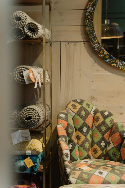 a chair that is sitting in front of a mirror, by Jan Tengnagel, trending on unsplash, arts and crafts movement, colored market stand, cozy calm! fabrics textiles, stood outside a wooden cabin, large motifs