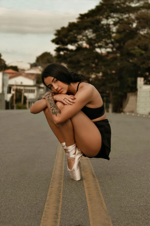 a woman sitting on a skateboard in the middle of the road, an album cover, trending on pexels, realism, ballet pose, madison beer, tattooed, profile image