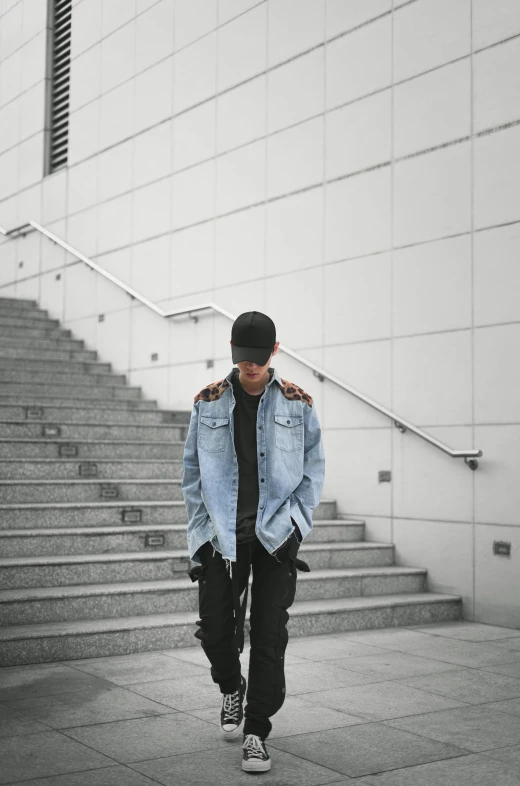 a man walking down a flight of stairs, an album cover, unsplash, realism, jean jacket, techwear clothes, confident pose, male ulzzang