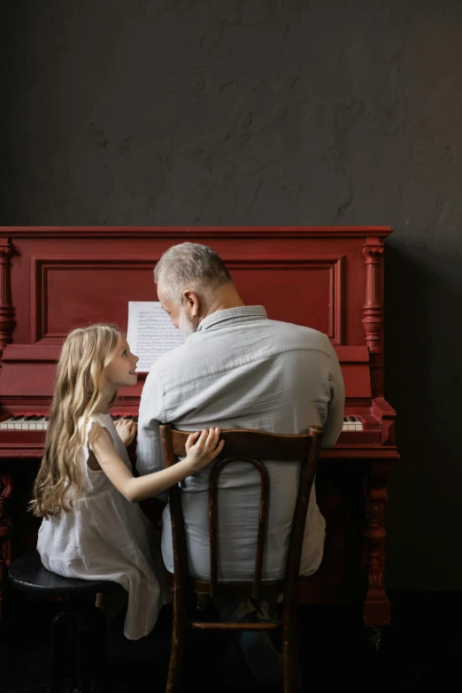a man and a little girl sitting at a piano, pexels contest winner, red brown and grey color scheme, old man, a blond, profile pic