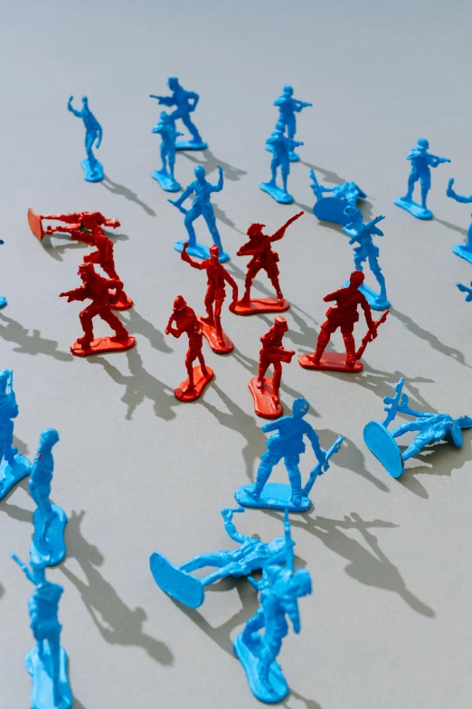 a group of toy soldiers standing next to each other, by Julian Allen, plasticien, blue and red, aerial shot, attacking, emergency countermeasures