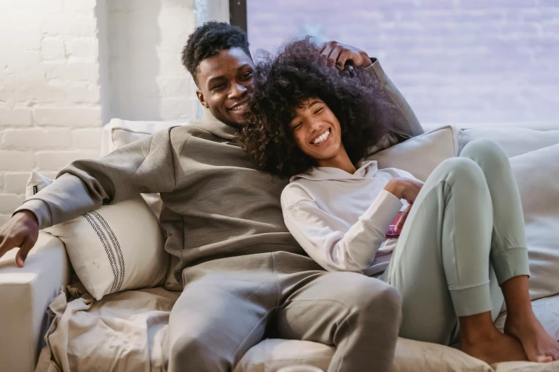 a man and a woman sitting on a couch, pexels contest winner, curly afro, happy girl, 1 4 9 3, instagram post