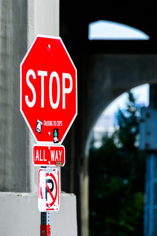 a red stop sign sitting on the side of a building, a picture, by Doug Ohlson, unsplash, graffiti, bridges, traffic signs, seattle, splash image