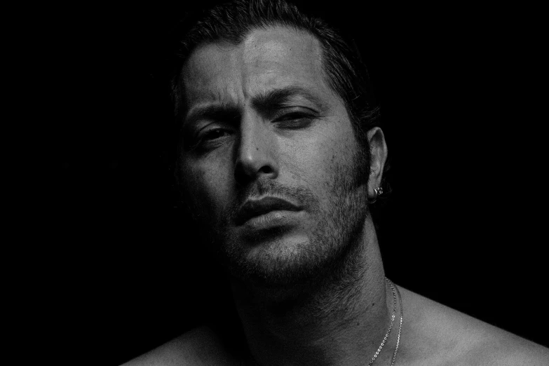 a black and white photo of a shirtless man, an album cover, by David Begbie, trending on pexels, hyperrealism, adam sandler, jenny saville and nicola samori, sideways glance, gal yosef