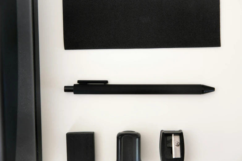 a pen, pencil, eraser, and eraser on a white surface, inspired by Colin McCahon, unsplash, square shapes, black canvas, educational display case, various posed