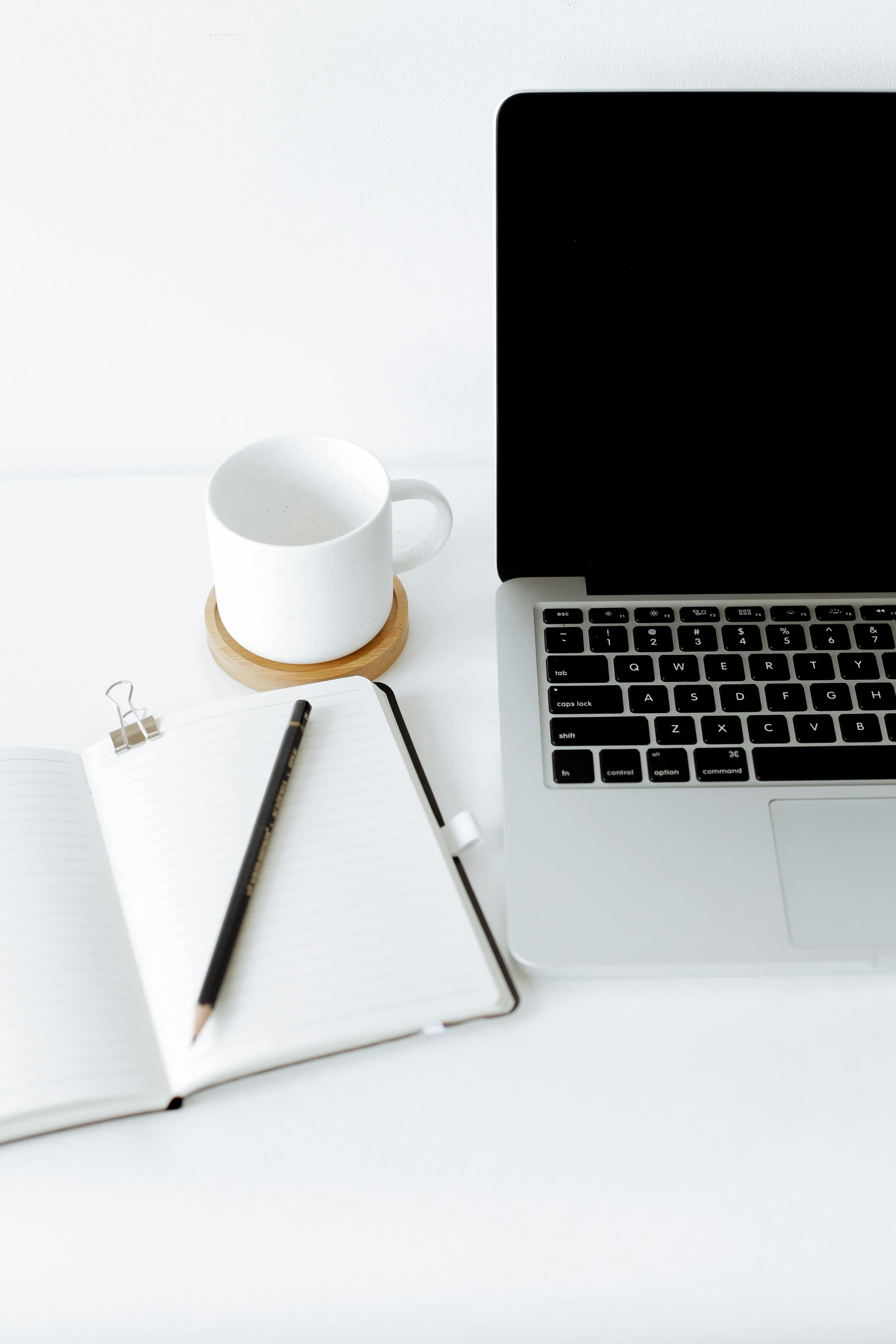 a laptop computer sitting on top of a desk next to a cup of coffee, black on white paper, white bg, multiple stories, detailed product image