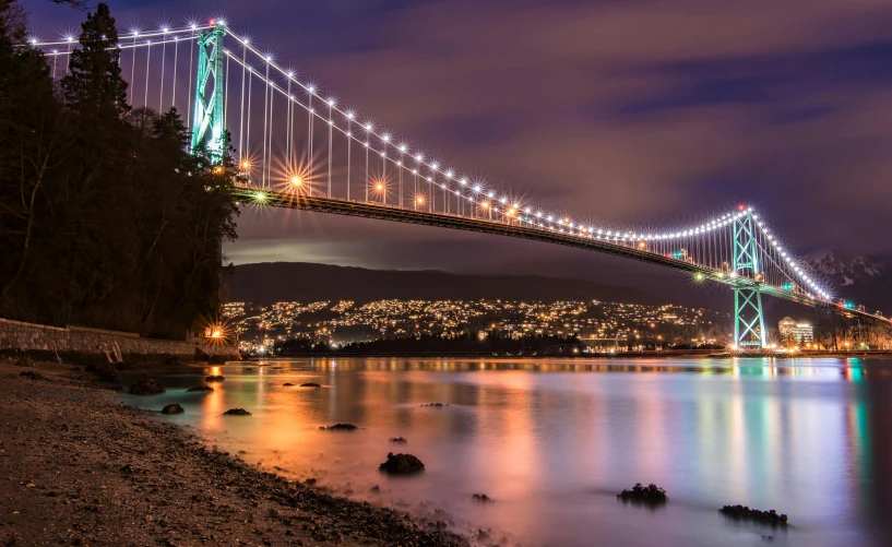 a bridge over a body of water at night, pexels contest winner, vancouver, a colorful, wellington, profile image