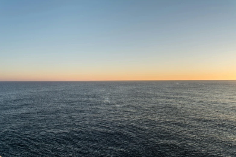 a view of the ocean at sunset from a cruise ship, by Johan Lundbye, minimalism, 2022 photograph, vastness, ignant, long view