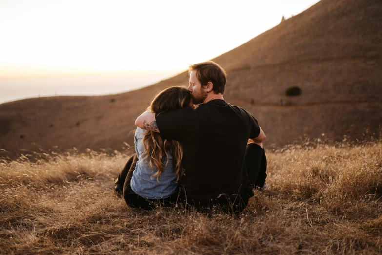 a man and a woman sitting on top of a hill, pexels contest winner, romanticism, sweet hugs, realistic », lachlan bailey, profile image