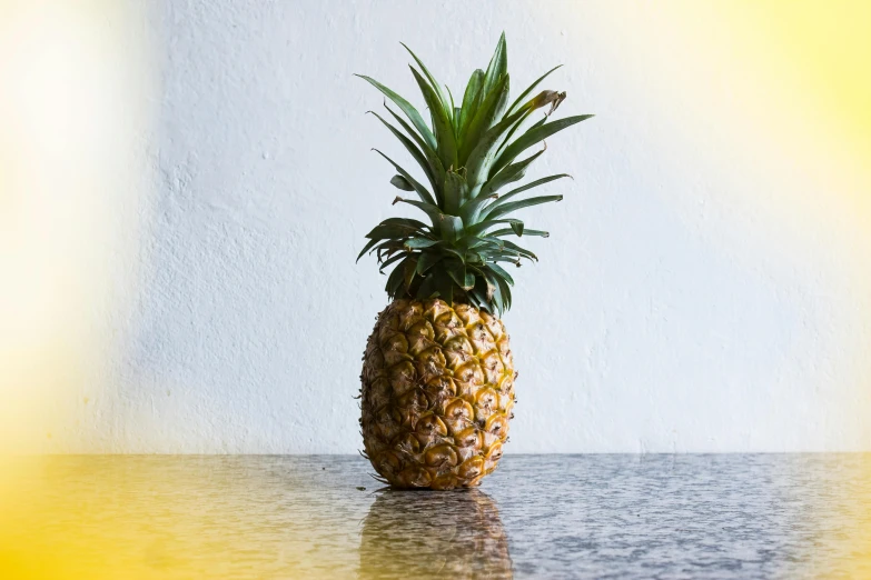 a pineapple sitting on top of a table, unsplash, looking left, various posed, indoor shot, no cropping