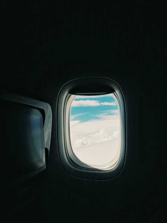 a view of the sky through an airplane window, pexels contest winner, surrealism, trending on vsco, portholes, in suitcase, 🚿🗝📝