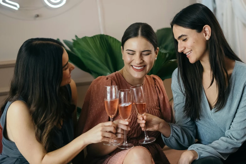 three women sitting on a couch holding wine glasses, pexels contest winner, happening, manuka, pink, profile image, champagne on the table