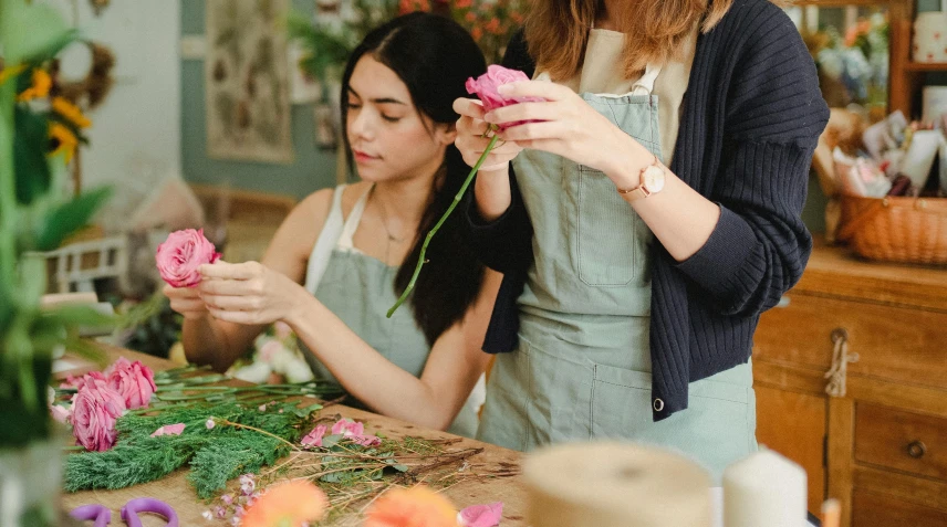 two women are working in a flower shop, by Nicolette Macnamara, trending on pexels, arts and crafts movement, rose twining, thumbnail, ready to model, half image