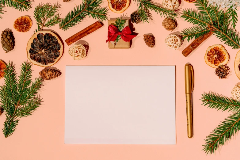 a white sheet of paper surrounded by christmas decorations, pale orange colors, thumbnail, background image, brown and pink color scheme