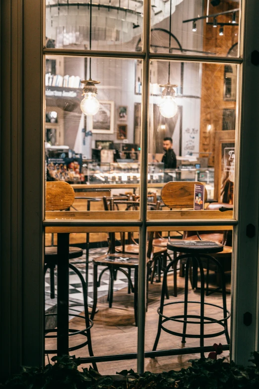 a view of a restaurant through a window, by Emanuel Witz, trending on unsplash, bakery, late evening, cavernous interior wide shot, brown