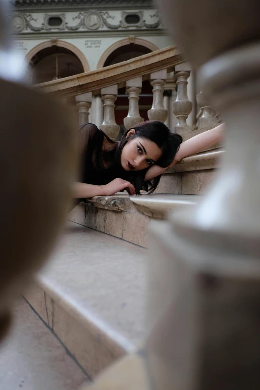 a woman laying on the steps of a building, a picture, inspired by irakli nadar, pexels contest winner, arabesque, :: madison beer, gothic and baroque, walking down a marble stairwell, headshot