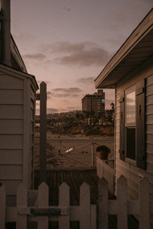 a couple of houses sitting next to each other, by Ryan Pancoast, unsplash contest winner, long beach background, ominous evening, views to the ocean, late afternoon
