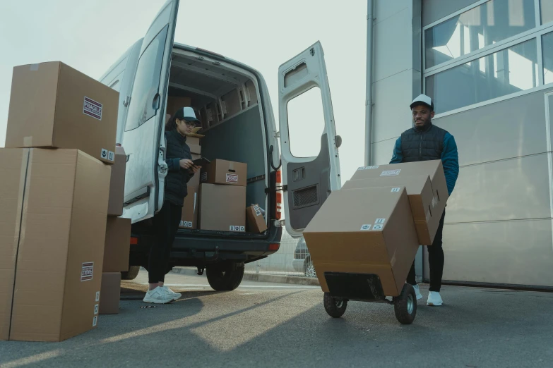 two men unloading boxes from a moving truck, pexels contest winner, avatar image, outlive streetwear collection, hd footage, brown
