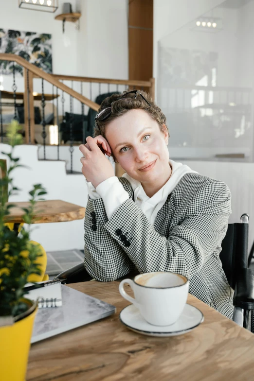 a woman sitting at a table with a cup of coffee, wearing a fancy jacket, jovana rikalo, avatar image, multiple stories