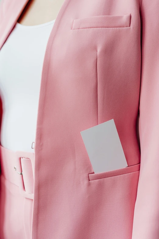 a woman with a business card in her pocket, inspired by René Burri, pexels contest winner, wearing a light - pink suit, square sticker, open jacket, without text