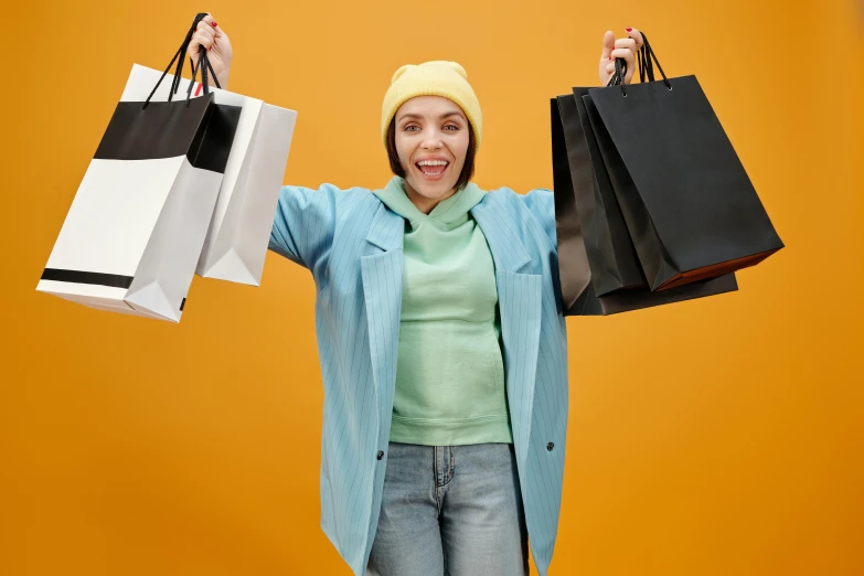 a woman holding shopping bags in her hands, pexels contest winner, baggy clothing and hat, all overly excited, yellow and black, avatar image