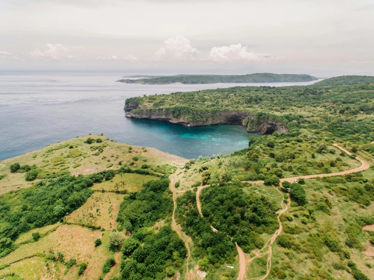 a large body of water sitting on top of a lush green hillside, pexels contest winner, archipelago, bali, flatlay, grey