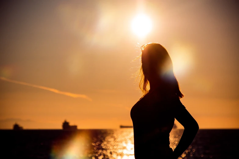 a woman standing in front of a body of water, sun in the background, profile image, beautiful female body silhouette, trending photo