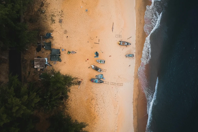 a group of boats sitting on top of a sandy beach, by Adam Marczyński, pexels contest winner, bird\'s eye view, laos, hd footage, maintenance photo