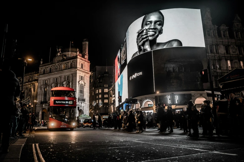 a red double decker bus driving down a city street, by Emma Andijewska, pexels contest winner, hyperrealism, neon billboards, square, people at night, by emmanuel lubezki