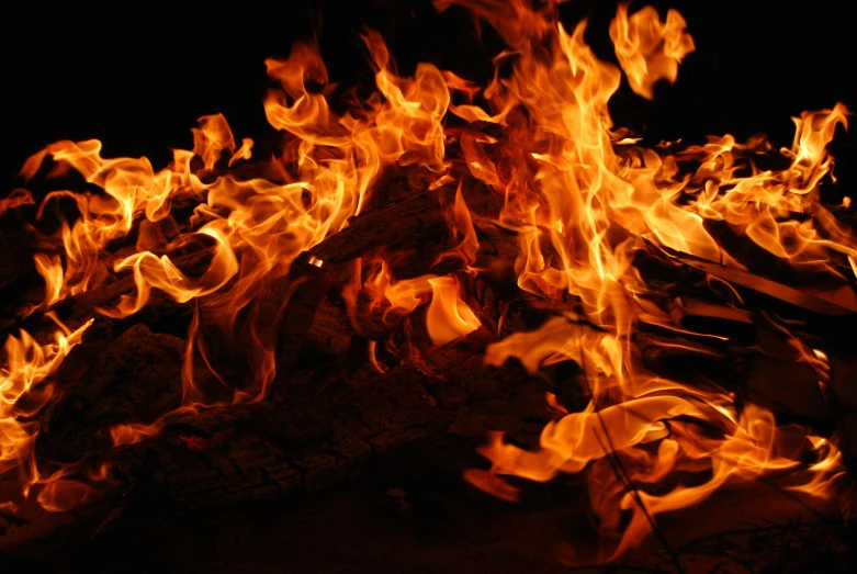 a close up of a fire on a black background, an album cover, pexels, campfire background, avatar image, multiple stories, 5 feet away