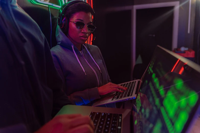 a woman sitting in front of a laptop computer, cyberpunk art, pexels, chillin at the club together, team ibuypower, serious business, hunting