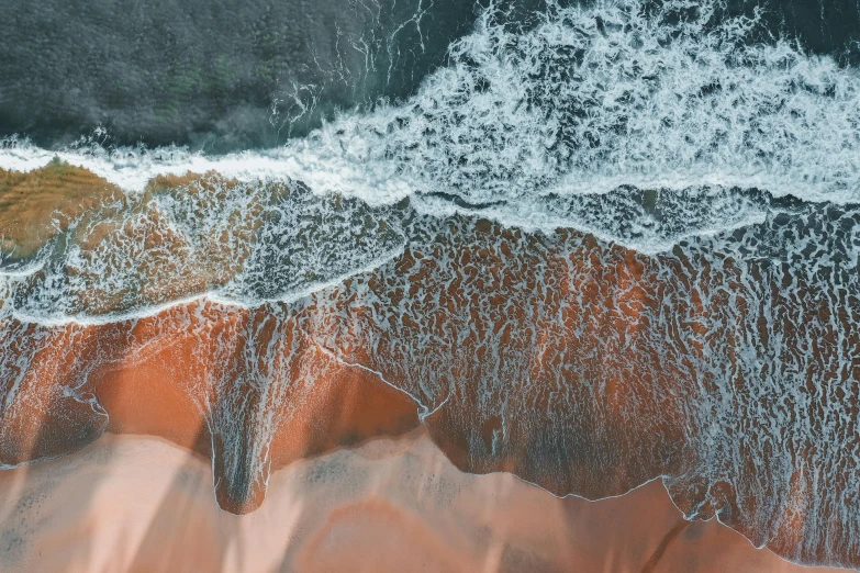 a person riding a surfboard on top of a sandy beach, unsplash contest winner, generative art, flowing salmon-colored silk, view from above on seascape, detailed water, black sand