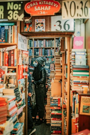 a book store filled with lots of books, pexels contest winner, a man wearing a black jacket, hooded figure, 🚿🗝📝, profile image