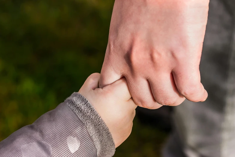 a close up of a person holding a child's hand, as well as the handyboy, swollen muscles, thumbnail, lightweight